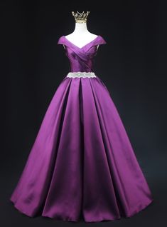 Functionally elegant, this purple prom dress is a perfect blend of classic beauty and modern style. The gown features an off-the-shoulder neckline with intricate pleating that adds a touch of sophistication. The fitted bodice is highlighted by a sparkling belt that accentuates your waist, creating a flattering silhouette. The full skirt, crafted from luxurious satin fabric, flows gracefully to the floor, providing a dramatic and regal look. The rich purple color ensures you stand out in any crowd, making this dress perfect for making a memorable entrance. Step into this gown and let its exquisite design and vibrant color elevate your prom night to an unforgettable experience. Purple Royal Dress, Royal Purple Dress, Sequins Prom Dress, Simple Satin, Corset Looks, Bodice Applique, Neck Corset, Purple Prom, Purple Prom Dress