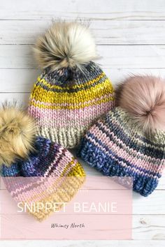 three knitted hats with two pom poms