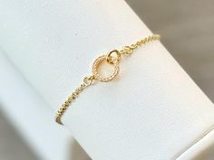 This beautiful CZ gold filled interlocking circle charm bracelet is adjustable and fits up to an 8" wrist. Bracelet slides to open and secure.  Layer it with any of our gold filled bracelets to create your own personalized stack.  Each bracelet is sold separately* 🤍 Made of: 14K Gold filled chain, hypoallergenic; (lead and nickel free); cubic zirconia; 14K Gold Plated Brass circle charm 🤍 15x8.5mm charm NOTE:  Color may vary slightly than picture due to different display devices and settings. Delicate Adjustable Gold Charm Bracelet, Delicate Adjustable Yellow Gold Charm Bracelet, Adjustable Gold Infinity Chain Bracelet, Gold Infinity Bracelet Adjustable, Gold Infinity Bracelets With Adjustable Fit, Adjustable Gold Infinity Bracelet, Dainty Adjustable Round Chain Bracelet, Adjustable Delicate Chain Bracelet, Elegant Adjustable Circular Chain Bracelet