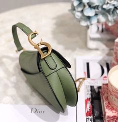 Description CHRSTN DR Saddle Bag Cedar Green Grained Canvas Spring For Women 20cm/8in CD Rep 1:1 Measurements: 19.5 x 6.5 x 16 cm / 8 x 2.5 x 6 inches The iconic Saddle bag is reinvented once more by Maria Grazia Chiuri. Featuring a Saddle flap with a magnetic ‘D’ stirrup clasp, it boasts a ‘CD’ signature on each side of the handle. The black ultramatte calfskin style is embellished with tonal metal hardware. The Saddle bag may be carried by hand or worn over the shoulder and can be customized w Christian Dior Saddle Bag, Louis Vuitton Shirt, Dior Saddle, Book Tote Bag, Maria Grazia Chiuri, Maria Grazia, Luxury Products, Stirrups, Evening Clutch Bag