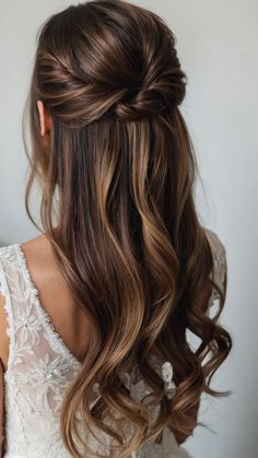 a woman with long hair in a half updo