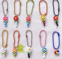 many different colored beads are attached to necklaces