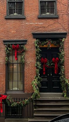 a red brick building decorated for christmas with wreaths and bows