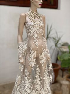 Beautiful, stunning off white/light ivory corded with sequins bridal lace. High quality tulle. WIDTH or Drop: 130 cm or 51 inches Price is per running meter. i.e Quantity 1 will fetch you 1m x 1.3m All orders of over one meter will be a continuous piece of lace. Default shipping is with post office airmail recorded delivery. For expedited orders contact us to find the best solution for your location. Cream Lace Dress With Scalloped Details, Cream Lace Dress With Delicate Details, Wedding Lace Dress With Scalloped Tulle, Cream Lace Dress For Wedding With Delicate Details, Cream Lace Dress For Party With Delicate Detailing, Cream Delicate Lace Dress For Party, Off White Lace Trim Wedding Dress, Fitted Cream Tulle Lace Dress, Form-fitting Cream Tulle Lace Dress