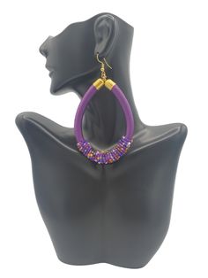 THE COLOR PURPLE! These large hoop earrings in purple with a mixture of beads are playful and so lightweight, making them a no brainer statement. Our favorite detail...subtle bead accents that add that little extra something. FEATURES ☆ Embroidery thread wrapped cord earrings☆ Beaded Accents☆ Color: Primary color purple with accent colors☆ Earring Back: Gold plated ball & coil fishhook ear wire☆ Earrings are light-weight ☆ Beautifully handmade by talented Kenyan artisans☆ Ships from the U.S. ☆ S Adjustable Purple Beaded Earrings With Colorful Beads, Purple Beaded Hoop Earrings With Round Beads, Purple Beaded Dangle Earrings, Purple Dangle Beaded Earrings, Trendy Purple Hoop Jewelry, Purple Beaded Dangle Hoop Earrings, Handmade Purple Teardrop Hoop Earrings, Purple Beaded Hoop Earrings, Cord Earrings