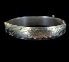 "Vintage Mid-Century Sterling Burkhardt Birks Canada Engraved Floral Thick Bangle Bracelet 7\" Item offered is an antique sterling engraved etched Burkhardt floral bangle bracelet. This bracelet consists of gorgeous etched floral designs. The clasp is a tab insert clasp. There is no safety chain attached. Condition is good, with age related wear. Inside is marked \"Sterling\" and \"B\". Please see photos provided as they are an extension of our written description. Measurements: Bracelet length: Formal Etched Bangle, Etched Bangle For Wedding, Formal Engraved Jewelry For Festivals, Engraved Round Bracelets For Festivals, Engraved Bracelets For Weddings And Festivals, Engraved Bracelets For Wedding And Festivals, Festive Engraved Bangle Bracelet, Etched Sterling Silver Bangle Bracelet Vintage Style, Vintage Engraved Bangle Bracelets