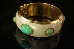 "This is a very beautiful, unique and vintage FRANCESCA ROMANA JADE CABOCHONS PEARL ENAMEL GOLD TONE bracelet. The fantastic bracelet has nice green jade cabochons with pearl enamel and gold tone metal (bottom has FRANCESCA ROMANA). The bracelet has a very exotic and elegant feel to it. It measures 7 1/4\" x 1\" . The bracelet is in very good condition. 0.7 BR" Elegant Green Cabochon Bracelets, Vintage Green Bangle For Wedding, Elegant Oval Green Bangle, Elegant Green Oval Bangle, Green Bangle For Collectible Jewelry, Green Bangle Jewelry Collectible, Green Bangle Collectible Jewelry, Gold Enamel, Green Jade