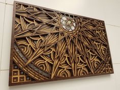 an intricate wood carving on the side of a wall