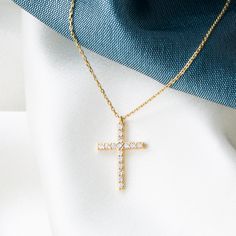 Experience the harmonious blend of tradition and elegance with our 14K Solid Gold Cross Necklace. This finely handcrafted piece features a petite cross pendant, measuring 7 mm wide and 11 mm tall, adorned with a singular cubic zirconia gemstone that captures the light and signifies purity. The skinny cable chain, available in lengths from 14 to 20 inches, provides a customizable fit for diverse preferences and comfort. Key Features: Refined Symbolism: Delicate cross pendant design for a modest e Necklace Stand, Necklace Cute, Gold Cross Necklace, Jewelry Accessories Ideas, Gold Cross Pendant, White Gold Chains, White Gold Necklaces, Cute Necklace, Gold Cross