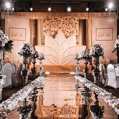 an elaborately decorated wedding ceremony set up with white and gold flowers on the table