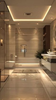 a bathroom with a large bathtub, sink and toilet next to a mirror on the wall