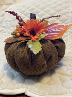 a decorative pumpkin sitting on top of a bed