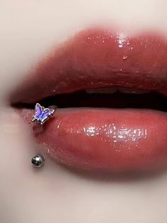 a woman's lips with a piercing on it