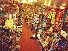 there are many books on the shelves in this store that is filled with greeting cards