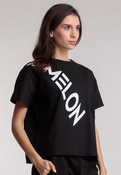 Women's t-shirt with the "AMELON" lettering in a free cut made of double-thread, high-quality cotton, durable fabric that maintains its shape and fits any figure perfectly. Shirt matches nicely with other items in our catalog. Materials: 95% Cotton, 5% Spandex Size on model - S Model`s height - 178cm Sporty Graphic Print T-shirt, Black Cotton Cropped T-shirt With Slogan, Short Sleeve Cropped T-shirt With Text Print, Black Cropped Graphic Tee With Screen Print, Black Cropped T-shirt With Text Print For Streetwear, Black Cropped T-shirt With Screen Print, Modern Short Sleeve Tops With Text Print, Black Cropped T-shirt With Slogan For Streetwear, Trendy Black Cropped T-shirt With Screen Print