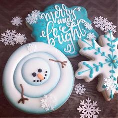 decorated cookies with frosting and decorations on a table