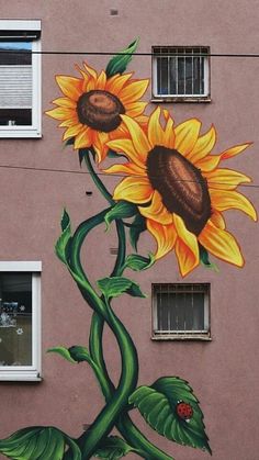 a mural on the side of a building with sunflowers painted on it