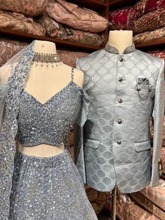 Men's Sherwani: Classic Bandhgala aka Nehru Jacket. The Indian version of a suit Comes with matching trousers Crafted with a collar neckline, full sleeves, and front button closure. Women's Bridal lehenga: Grey color lehenga intricate with fully sequence, studs motifs thread embroidery and crystal stone flared lehenga. Styled with same work blouse and net dupatta. Fabric: Net Elegant Party Lehenga With Naqshi Details, Party Wear Unstitched Suit With Long Sleeves For Reception, Bollywood Style Fitted Suits With Resham Embroidery, Festive Party Lehenga With Naqshi Detailing, Party Bollywood Lehenga With Naqshi Detailing, Formal Naqshi Lehenga With Traditional Drape, Festive Formal Lehenga With Naqshi Detailing, Festive Formal Lehenga With Naqshi, Formal Lehenga With Naqshi In Traditional Drape