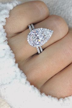 a woman's hand with a diamond ring on it