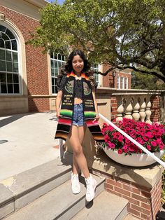 a woman is standing on the steps outside