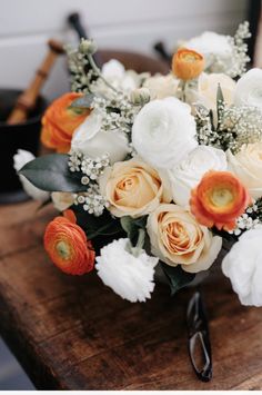 a bouquet of flowers sitting on top of a wooden table