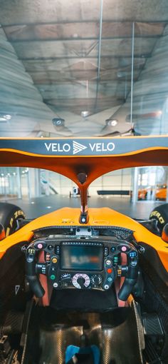 the interior of a vehicle with steering wheel and dash board on display in a car showroom