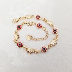 14k Gold Plated Red Evil Eye With Elephants Women's Protection Bracelet It Has A Slightly Rose Gold Tone New Red Bracelet With Adjustable Chain As Gift, Red Bracelet With Adjustable Chain For Gift, Handmade Red Chain Bracelet As Gift, Handmade Red Chain Bracelet Gift, Handmade Red Chain Bracelet For Gift, Elegant Red Bracelets For Good Luck, Dainty Red Charm Bracelet As A Gift, Gift Red 14k Gold Bracelet, Red 14k Gold Dainty Bracelet