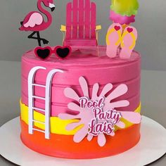 a birthday cake with pink and yellow frosting, flamingos on the beach chair