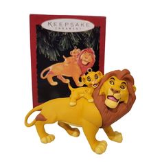 two lion figurines sitting next to each other in front of a red box