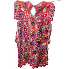 A traditional style of blouse (kanchli or choli) from the Banjara nomadic tribe of Rajasthan. Festival Chanderi Kaftan With Mirror Work, Red Bohemian Traditional Wear For Ceremonies, Traditional Festival Kurta With Embroidered Border, Chanderi Kaftan With Mirror Work For Festivals, Festive Embroidered Kaftan With Border Detail, Festive Multicolor Embroidered Kaftan With Embroidered Border, Traditional Festive Kaftan With Mirror Work, Bohemian Traditional Wear For Puja Festivals, Traditional Patterns Kurta For Festivals