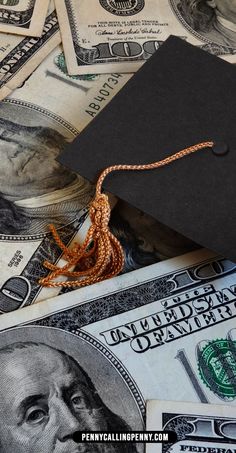 a graduation cap sitting on top of money