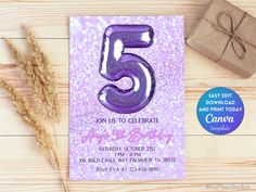 a purple birthday card with the number five on it next to a present box and some dry grass