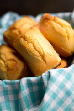 some food that is in a bowl on a tablecloth with a blue and white checkered cloth