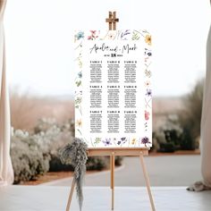 an easel with a wedding seating chart on it