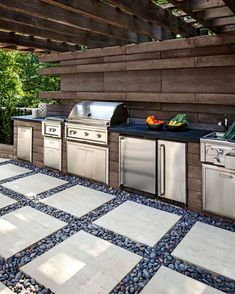 an outdoor kitchen with stainless steel appliances and granite flooring is featured in the article spectacular landscapes