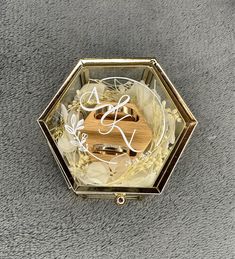 a wooden and glass box with some writing on the inside that is sitting on a carpeted floor