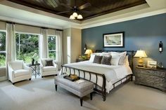 a bedroom with blue walls and white furniture