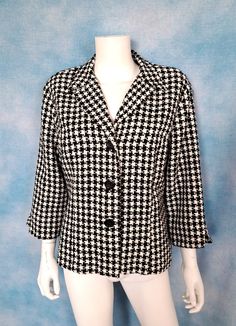 "A 3-button fitted jacket/blazer in a soft woven classic black and white houndstooth. Wide, short lapel and bracelet length sleeves. No pockets. Padded shoulders. Slight pilling here and there but otherwise good condition. Decade: 1990s Label: Dressbarn, Made in USA of imported fabric Material: acrylic with polyester lining Closure: 3 buttons Vintage Condition: very good to excellent (From a pet and smoke free home) Measurements are taken flat and doubled where necessary. This is marked size XL. Neck: 27\" Shoulder span: 18\" Sleeve length: 18.5\" Upper arm: 16\" Cuff: 11\" Bust: 44\" Waist: 38\" Bottom opening: 47\" Length: 24\" NO RETURNS - ALL SALES ARE FINAL. Please check the measurements I've given, and measure yourself or a garment that fits you well to compare, before committing to Fitted Semi-formal Outerwear With Houndstooth Pattern, Fitted Houndstooth Button-up Outerwear, Spring Fitted Houndstooth Blazer, Fitted Houndstooth Blazer For Spring, Classic Long Sleeve Lined Blazer, Vintage Fitted Houndstooth Blazer, Fitted Vintage Houndstooth Blazer, Casual Fitted Houndstooth Blazer, Classic Lined Blazer For Work