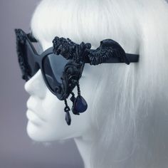 Hand-decorated black filigree ornate sunglasses dripping with beading. Please note: There is no ready-made sunglasses box large enough for these sunglasses. These sunglasses are wearable art and need to be treated with due care. While i have taken every possible care to make them sturdy throwing them in a bag careless may damage them. Treat them as you would a precious thing... Approx measurements: Inner arm to arm: 13cm Total width: 16cm Approx Weight: 42g Thank you in advance for not PM'ing me Black Glass Sunglasses For Festival, Vintage Black Sunglasses For Festival, Gothic Black Sunglasses For Party, Black Gothic Sunglasses For Party, Dark Beauty Magazine, Sunglasses Box, Uv400 Sunglasses, Goth Wedding, Black Lipstick