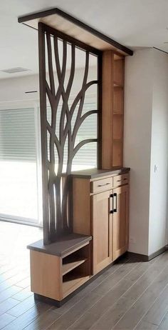 an empty room with wooden cabinets and wood flooring