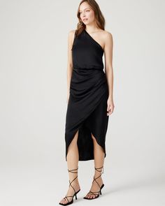 Stay effortlessly stylish in the ADELE dress, a versatile addition to your wardrobe. Made from washed satin fabric, this one-shoulder midi dress features an elastic waist and wrap front skirt for a flattering silhouette. With a cinch tie shoulder, this black dress is perfect for any occasion. One-shoulder midi dress Ruched tie detail at shoulder Elastic waist Wrap skirt with side draping Length: 51" 100% polyester Care instructions: hand wash cold separately, do not bleach, lay flat to dry, low Adele Dress, One Shoulder Midi Dress, Midi Wrap Dress, Adele, Wrap Skirt, Satin Fabric, Lay Flat, Dress Black, Jumpsuit Dress