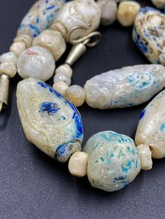 The Rare and Unique Beads necklace of Ancient Rough Rock Crystals Almost every Bead is Beautifully Carved and Beautifully painted with Blue color Rare and unique Item for collection Fast and Free shipping service Artistic Beaded Necklace With Large Beads, Artisan Single Strand Czech Glass Beaded Necklace, Artisan Single Strand Czech Glass Beaded Necklaces, Artisan Czech Glass Large Beads, Artisan Large Czech Glass Beads, Artisan White Single Strand Beads, Artistic White Round Beads Jewelry, Artistic White Round Bead Jewelry, Artistic White Round Beaded Jewelry