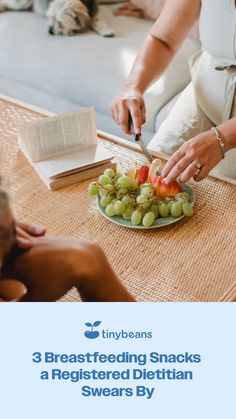 a woman is cutting vegetables on a plate with a book and dog in the background