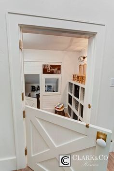 an open door leading into a room with white walls and wood flooring on the other side