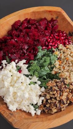 a wooden bowl filled with different types of food