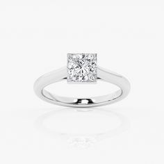 a princess cut diamond ring on a white background