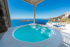 an outdoor swimming pool overlooking the ocean