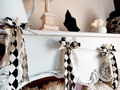 black and white decorations are hanging on the mantle