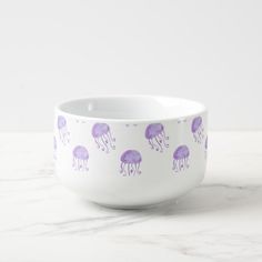 a white bowl with purple jellyfish on it