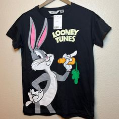 Newest Tag Looney Tunes H&M Shirt For 12/14 Black Cartoon Print Tops For Spring, H&m Black Cotton T-shirt, H&m Black Graphic Print Tops, Casual Gray Cartoon Print Top, Casual Gray Tops With Cartoon Print, H&m Black Cotton Top, H&m Black Casual Shirt, H&m Black Short Sleeve Tops, Casual Black H&m Shirt